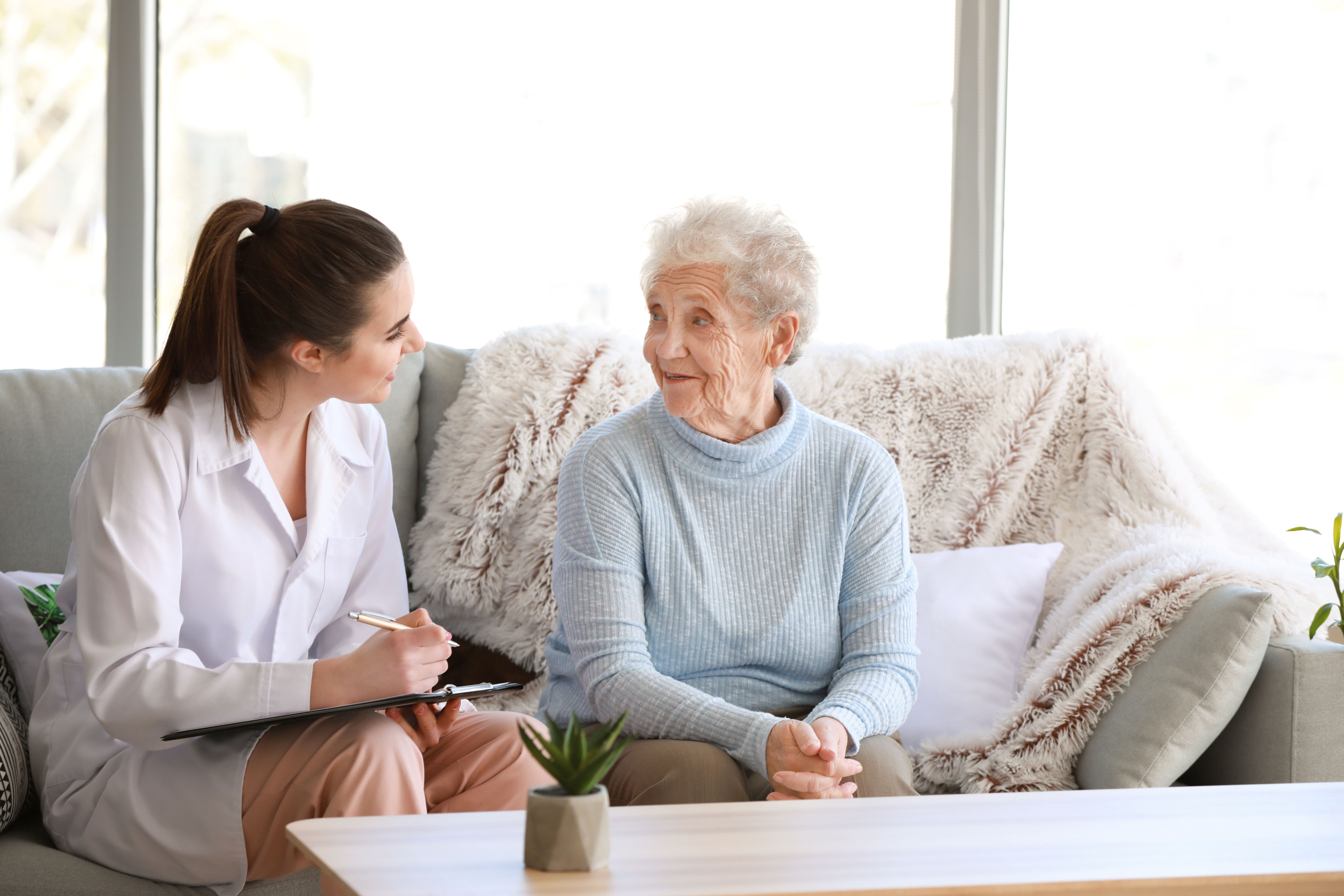 Healthcare provider with senior woman in home
