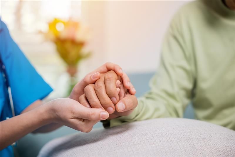 Closeup hand. Young woman helping hold hands offering her senior man support