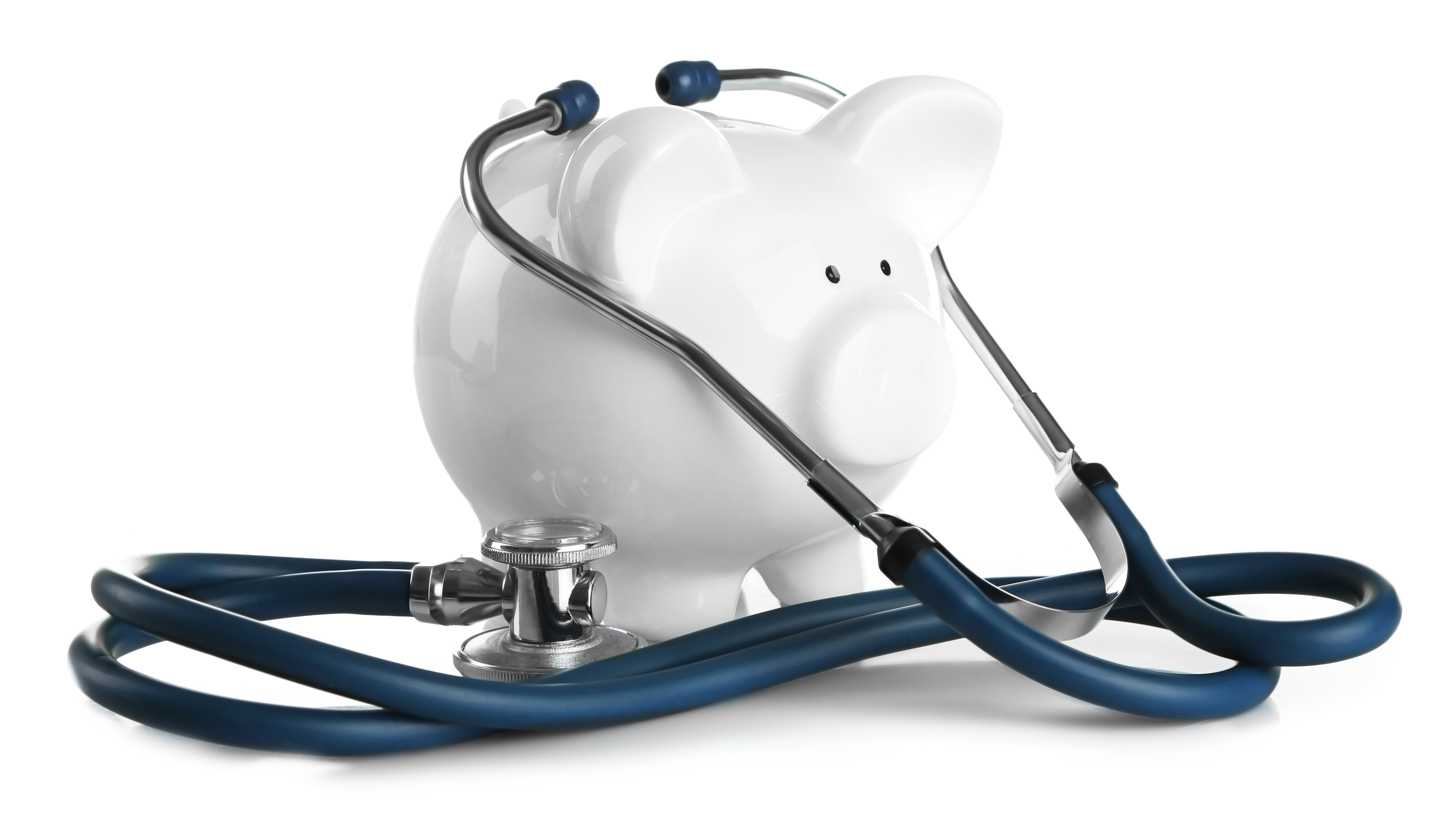 Piggy bank with stethoscope isolated on white