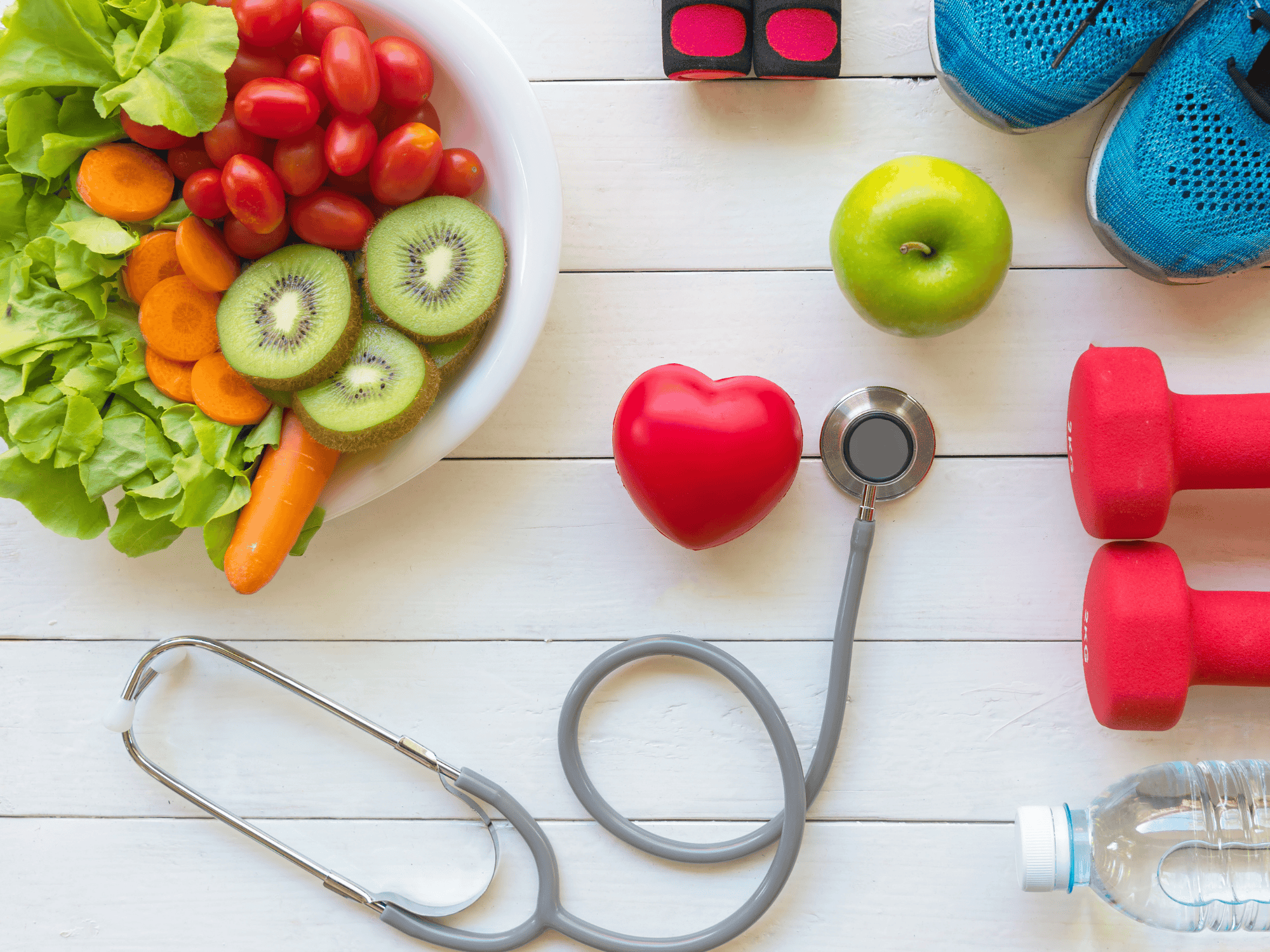 Health Care. Fresh vegetable salad and green apple with medical stethoscope for dietitian depiction 
