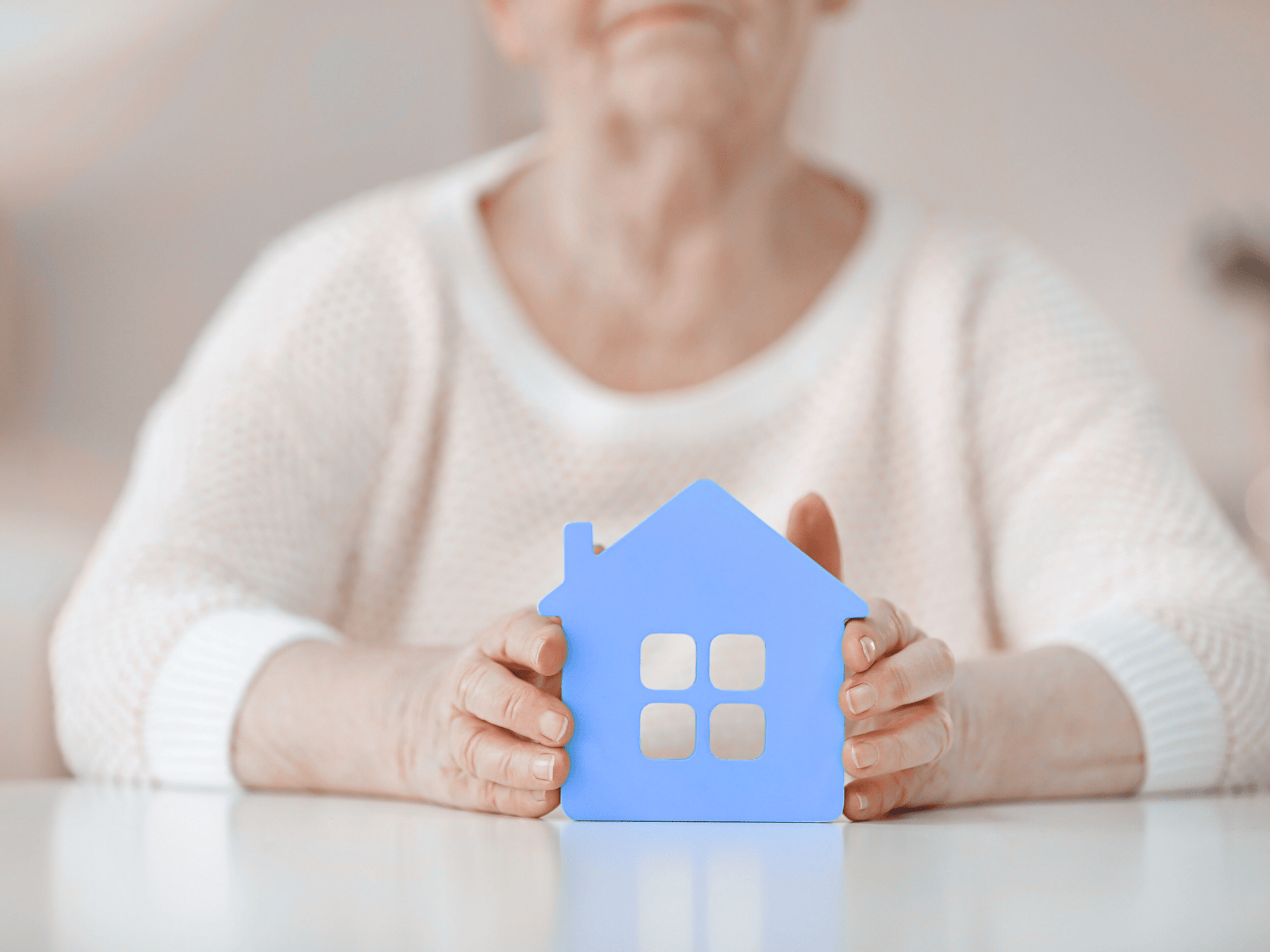 Woman sitting at table in her home.
