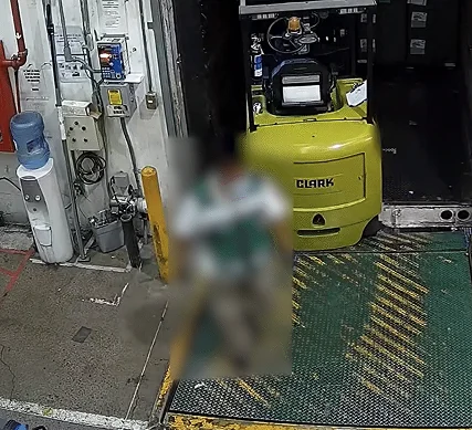 Dock worker fully blurred next to a forklift