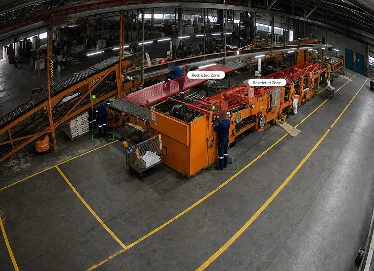 Worker climbing on a machine line, marked by a detection box