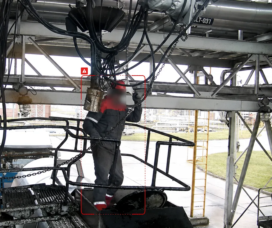 Tanker loading gantry at a refinery, with an operator marked on the platform