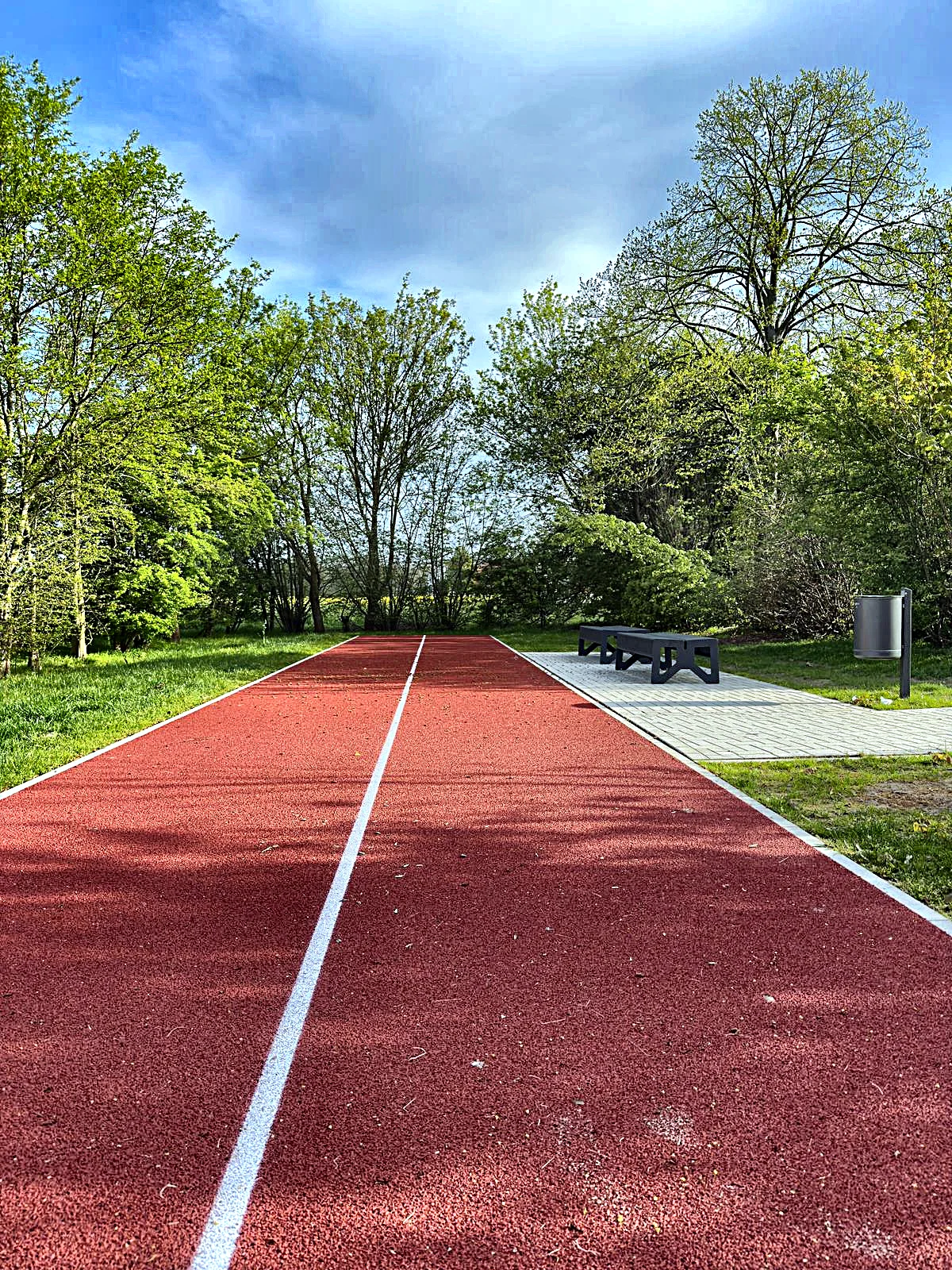 Finnbahn mit Laufbahn und Weitsprunggrube, eingebettet in Grünflächen