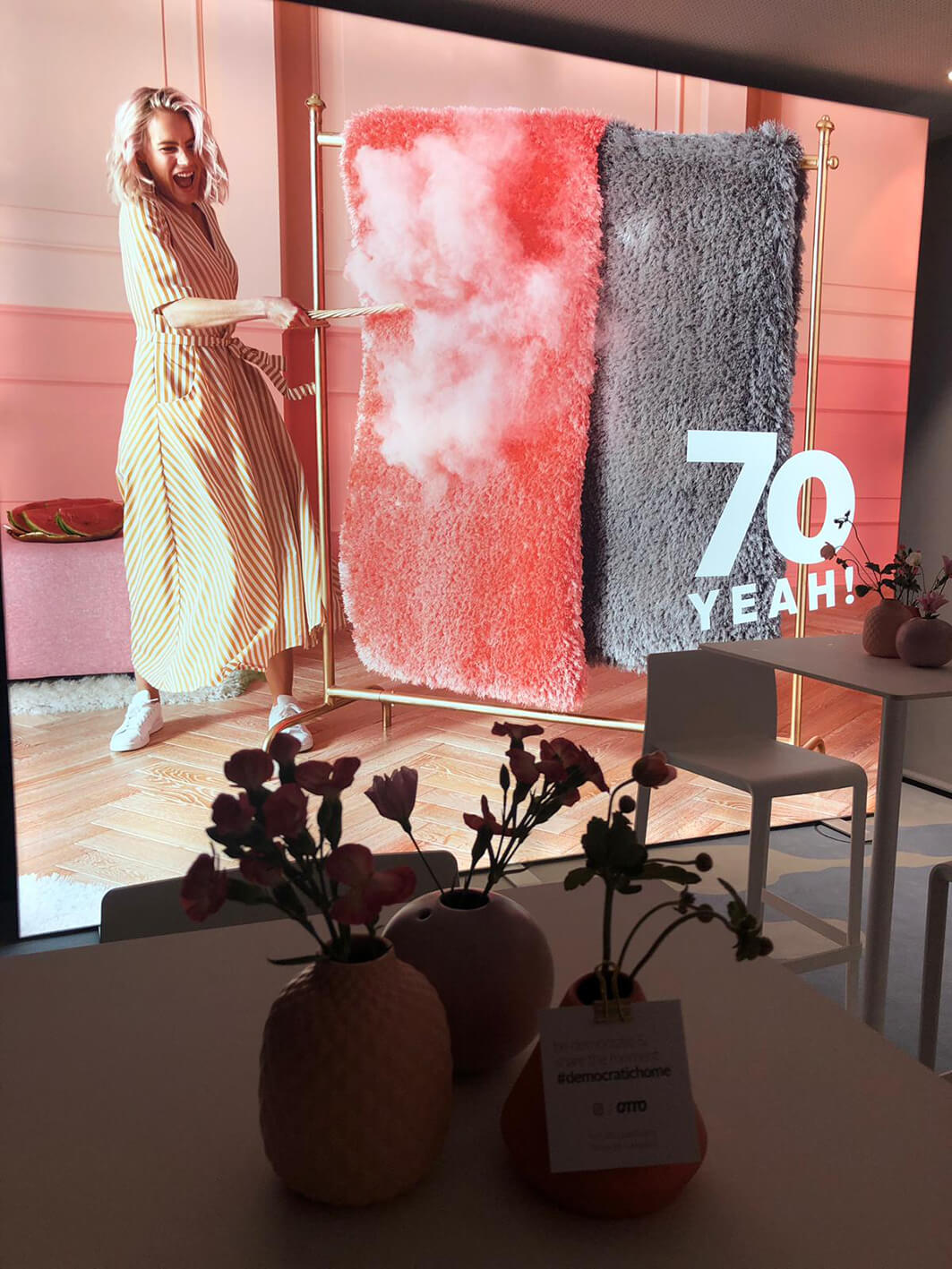 A model dusting pink carpets.