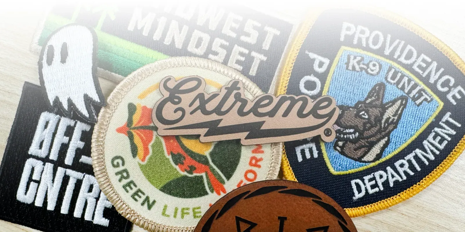 A stack of different types of patches. Embroidered, leather & sublimation.