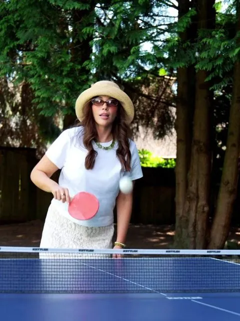 Jenn's patient care manager playing ping pong on a summer pool day