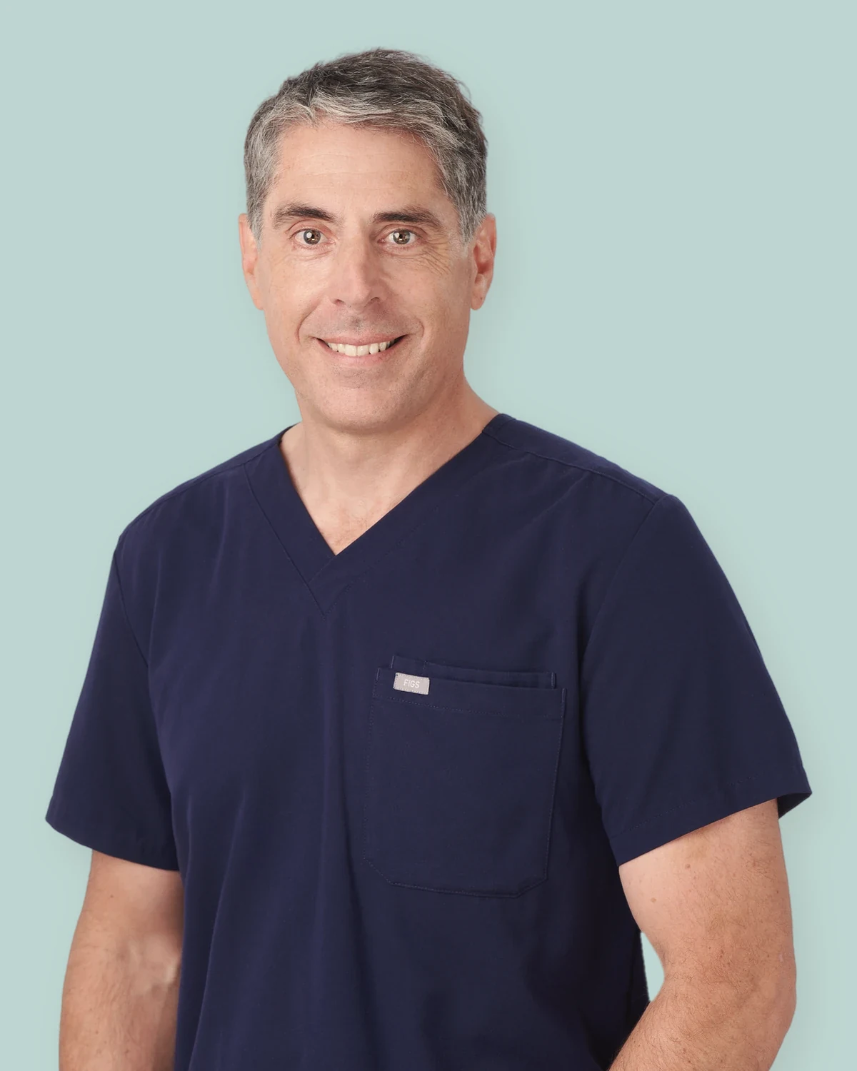 Dr. Thomas Buonassisi, MD, FRCSC, in surgical scrubs at 8 West Clinic