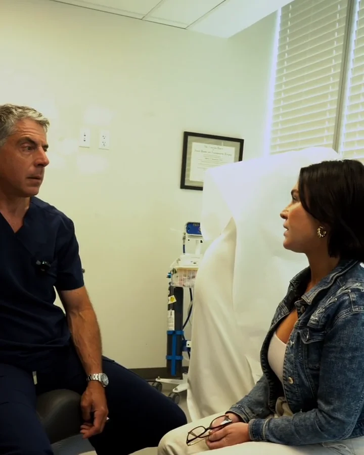 Dr. Buonassisi and Jenn, RN, talking in a consultation room