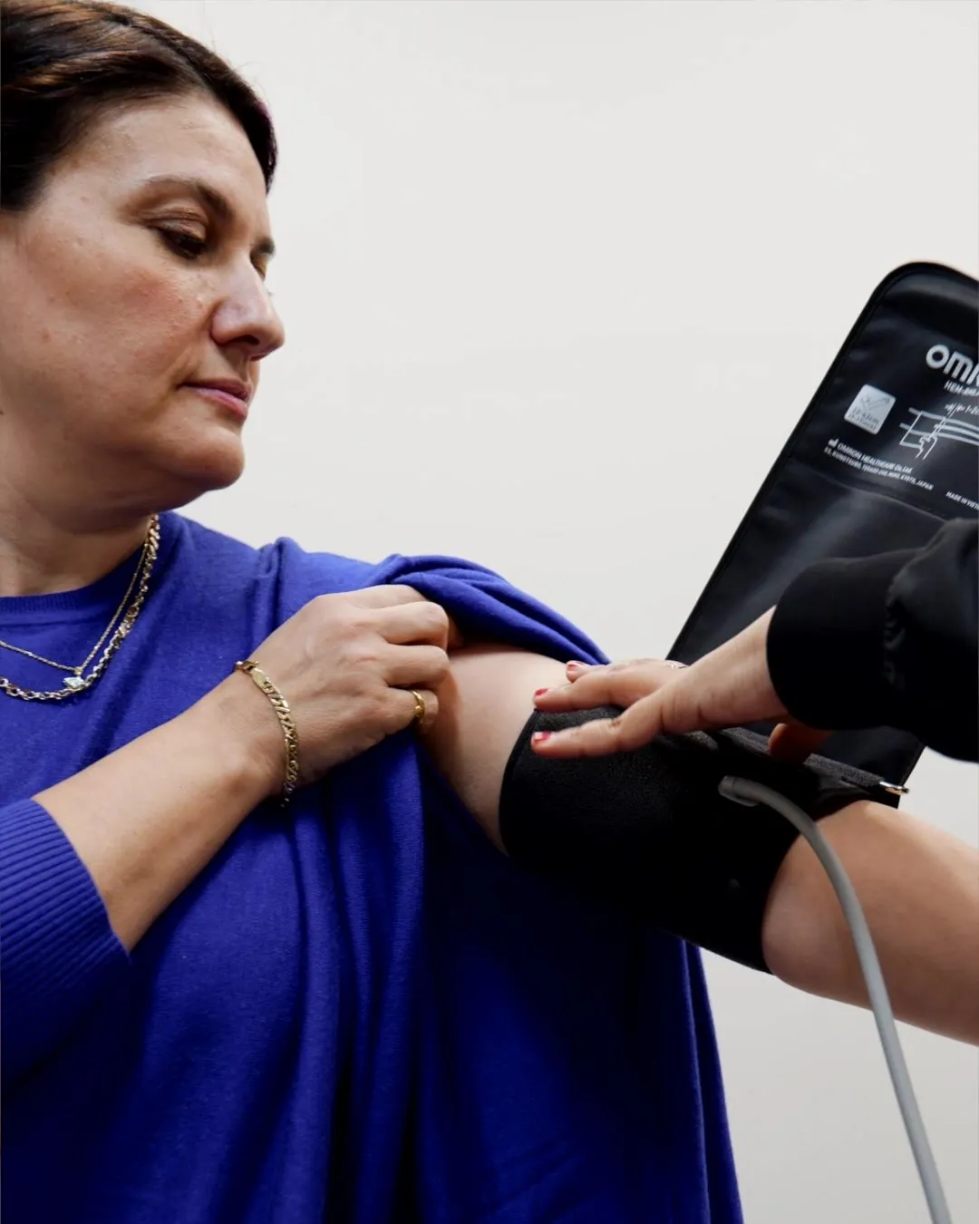A member of our team doing a health check with a woman at 8 West Clinic