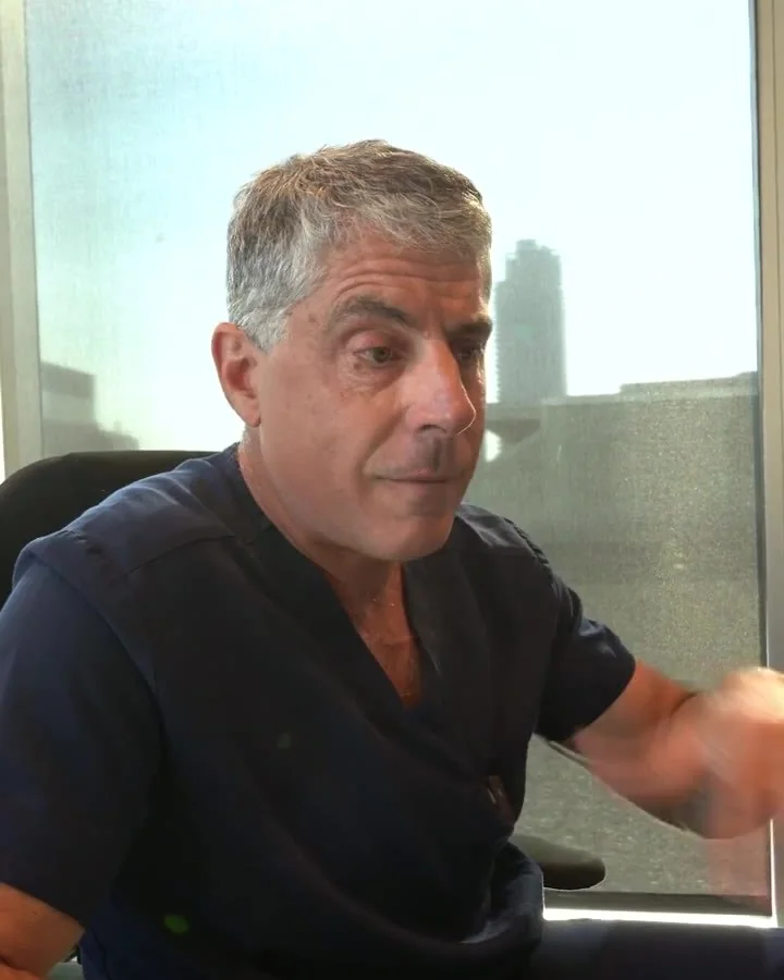 Dr. Buonassisi at a screen, pointing to a patient's profile photo