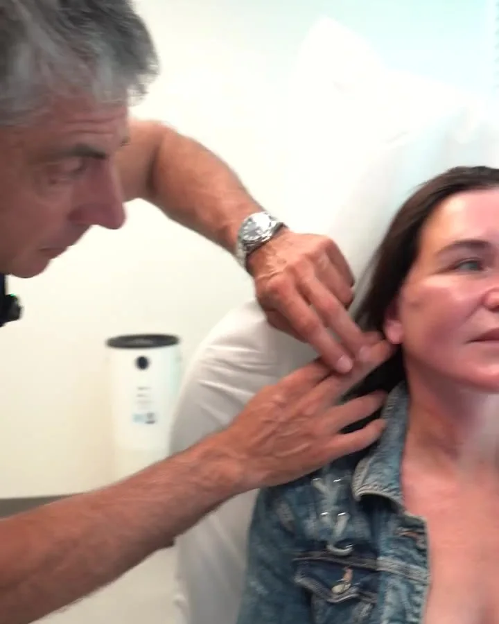 Dr. Buonassisi checking Jenn's jawline at her follow-up visit