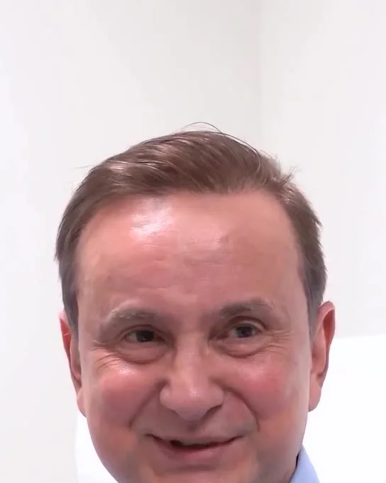 A man smiling, ten weeks after his facelift and neck lift