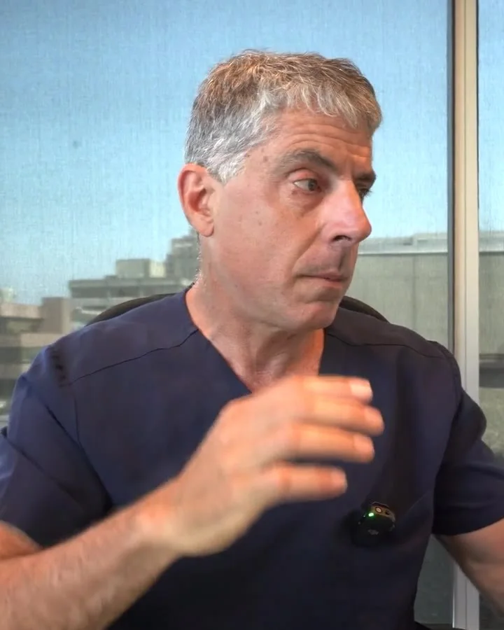 Dr. Buonassisi in his office, explaining a patient's facelift