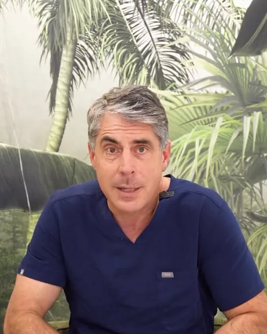 Dr. Buonassisi in the clinic, answering a question about lower eyelid surgery