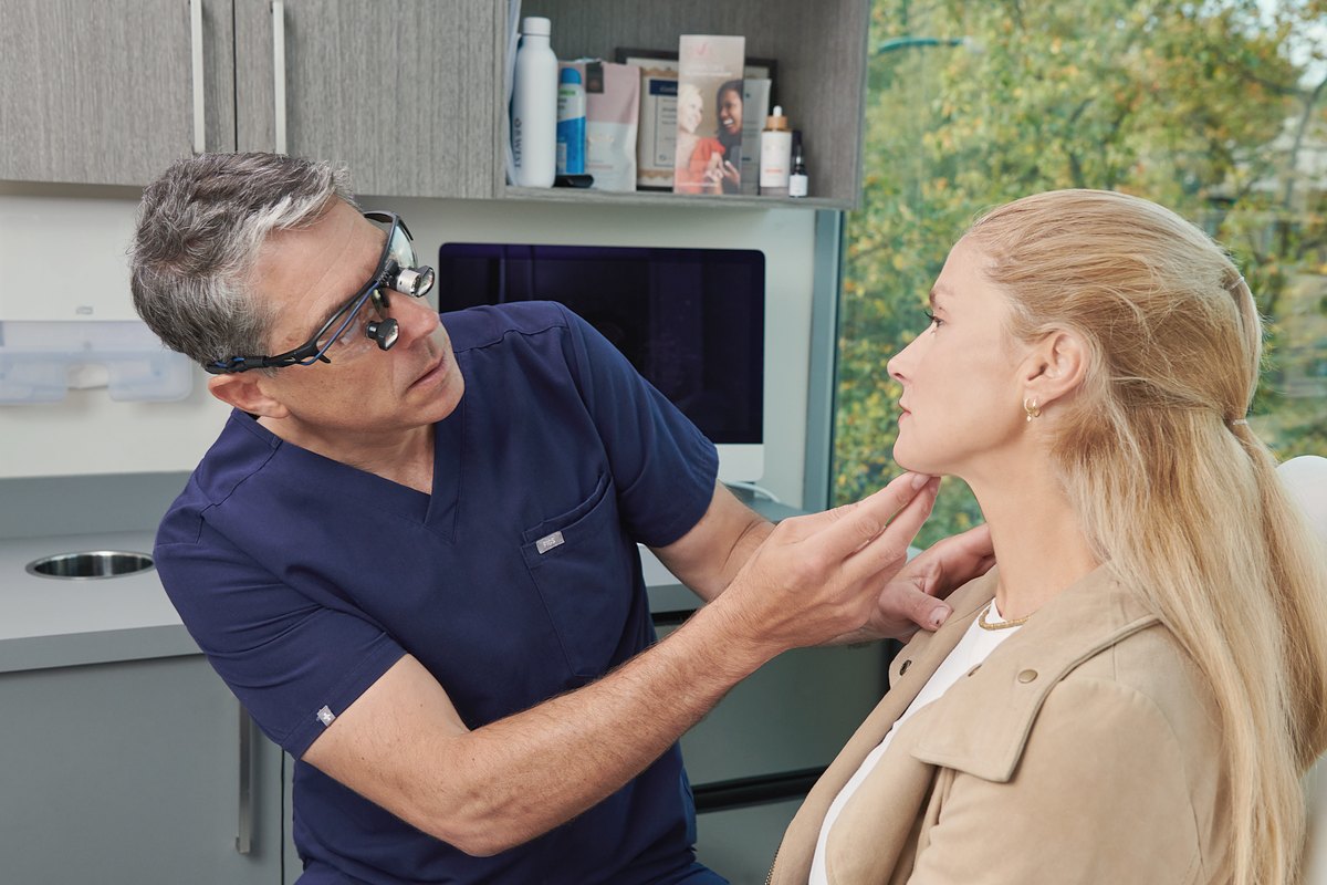 Dr. Buonassisi assessing the jaw and neck in a consultation at 8 West Clinic