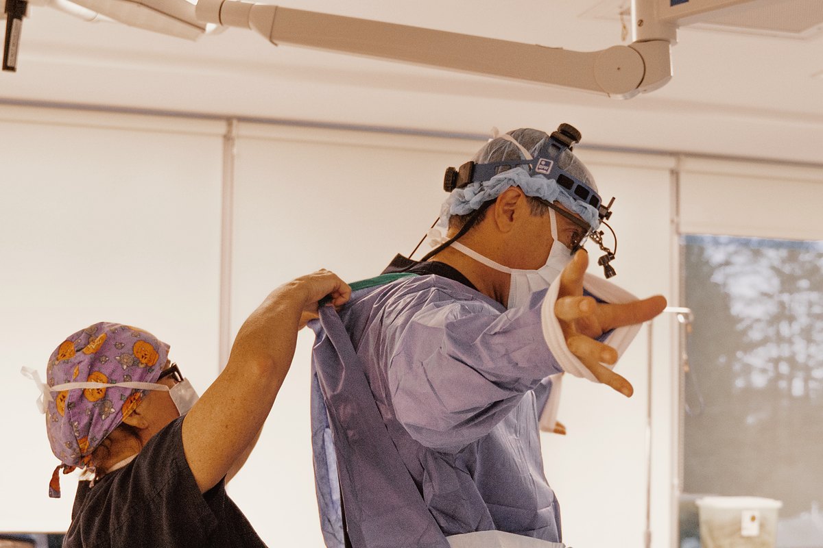 Dr. Buonassisi being gowned before surgery at 8 West Clinic