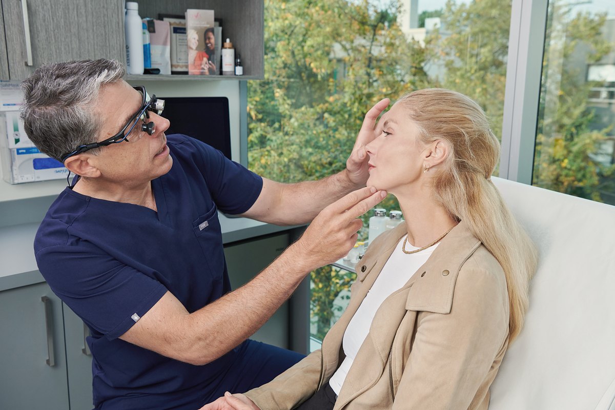 Dr. Buonassisi assessing the face in a consultation at 8 West Clinic