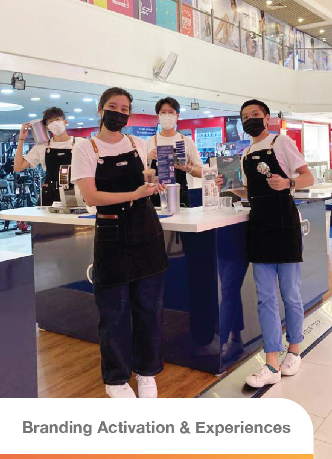 A group of four individuals who appear to be the event crew, smiling for the picture during a pop-up event for De'Longhi, a renowned coffee machine brand.