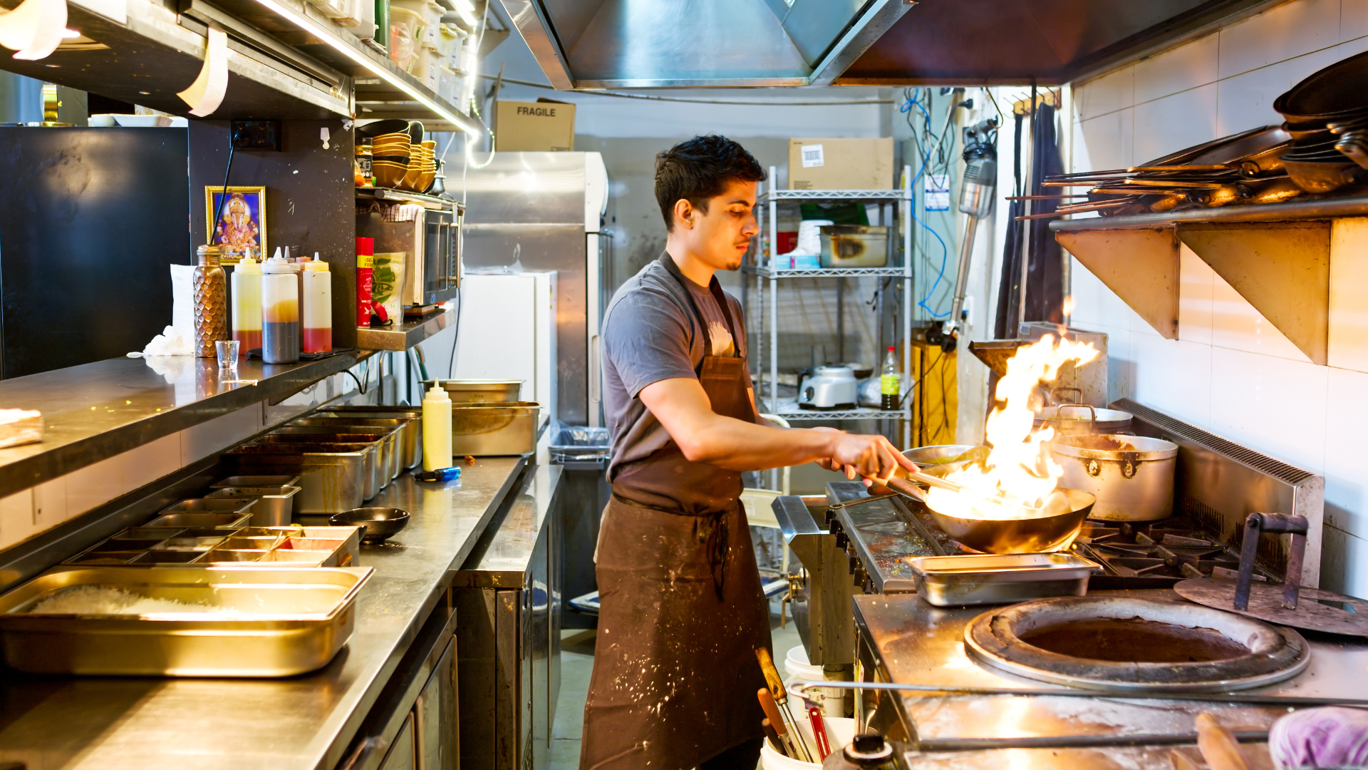 Chef cooking in a commercial kitchen for a takeaway business