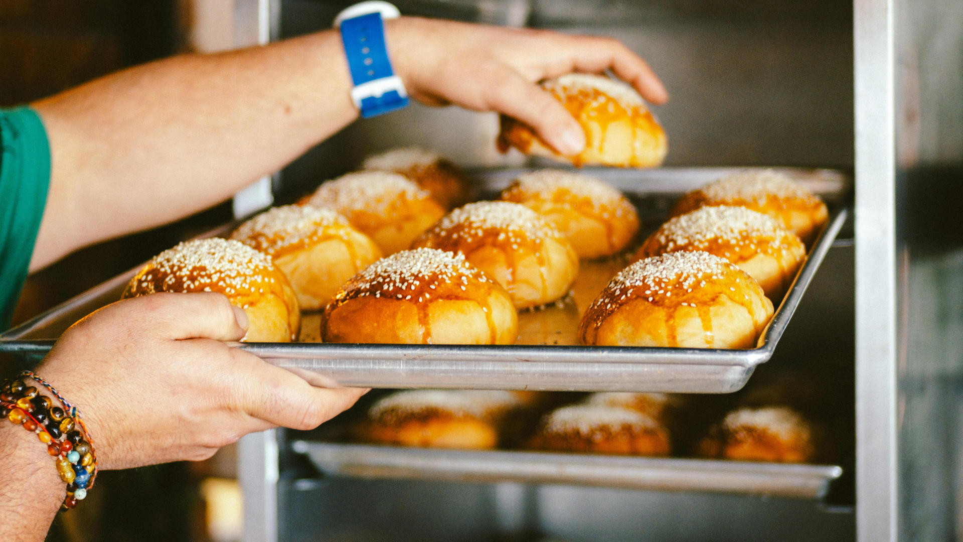Freshly baked pastries on trays in a commercial cafe kitchen