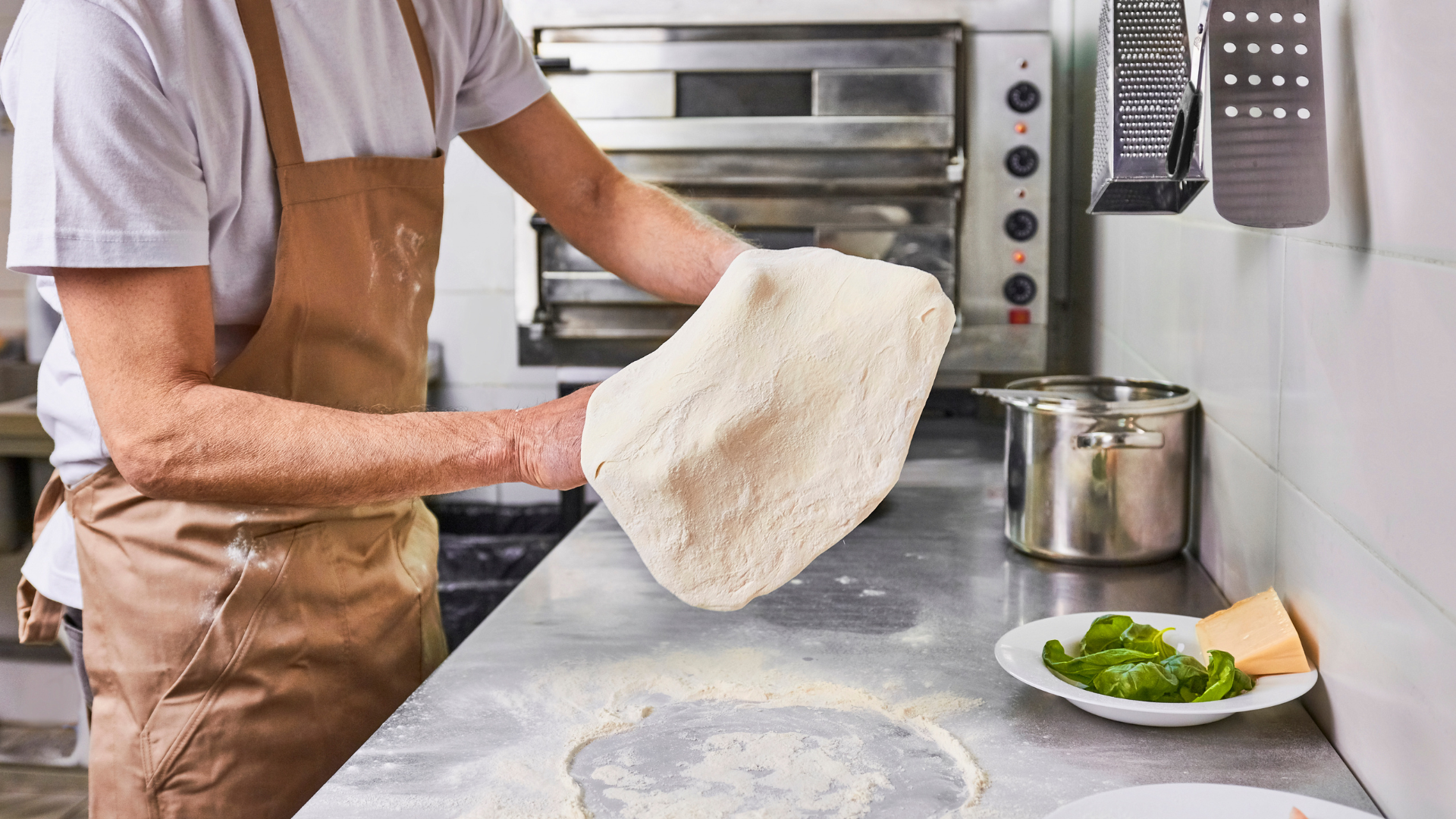 Baker preparing dough in a commercial kitchen for a temporary bakery setup