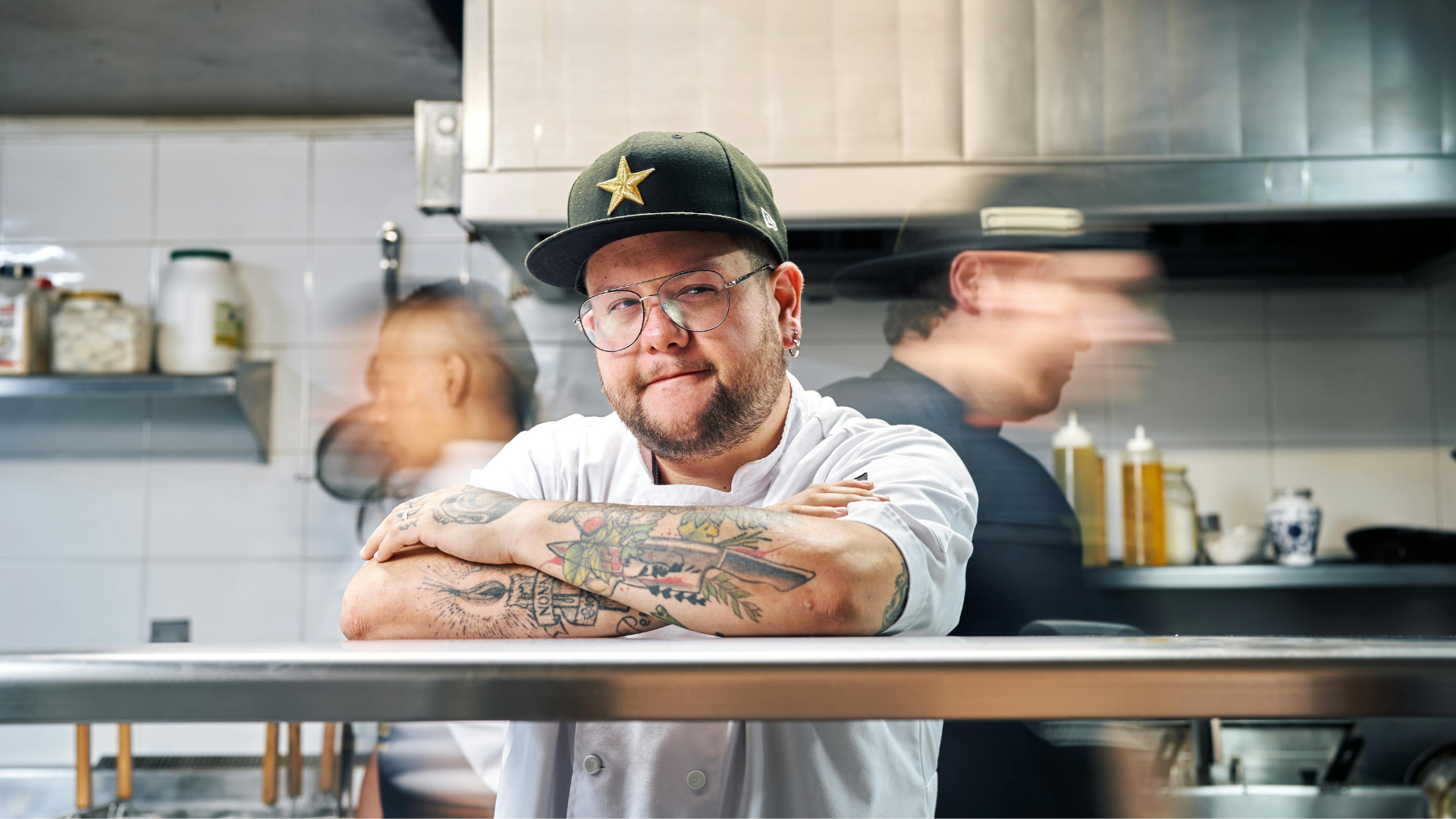 Chef working in a busy dark kitchen environment with minimal staff