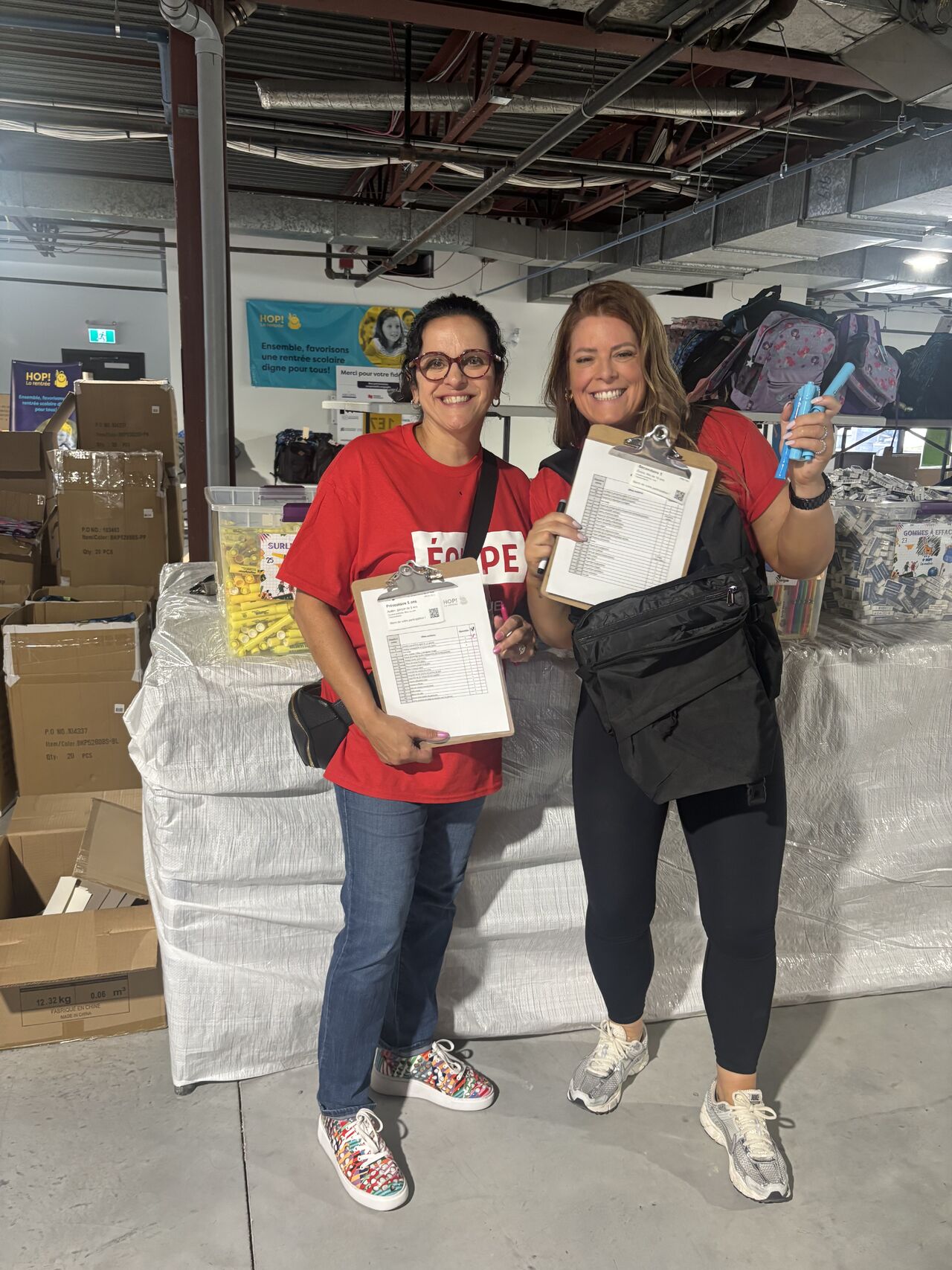 a group of people organizing school supplies in a storage place