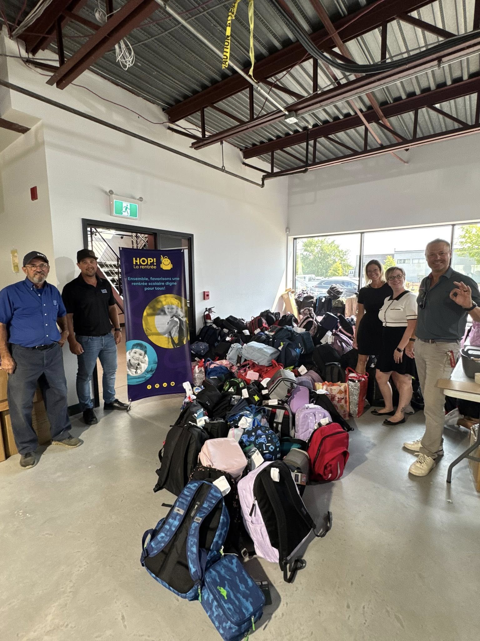 a group of people organizing school supplies in a storage place