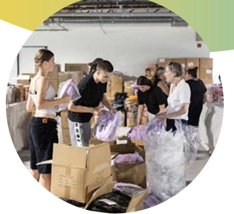 a group of volunteers holding donation bags