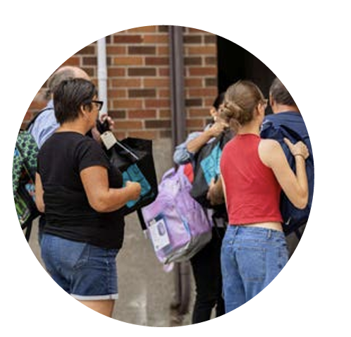 a yougn volunteer holding school supplies