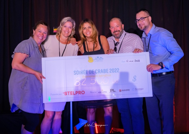 woman holding fundraiser cheque