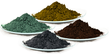 Four piles of powder in different colours, yellow, green, black and brown