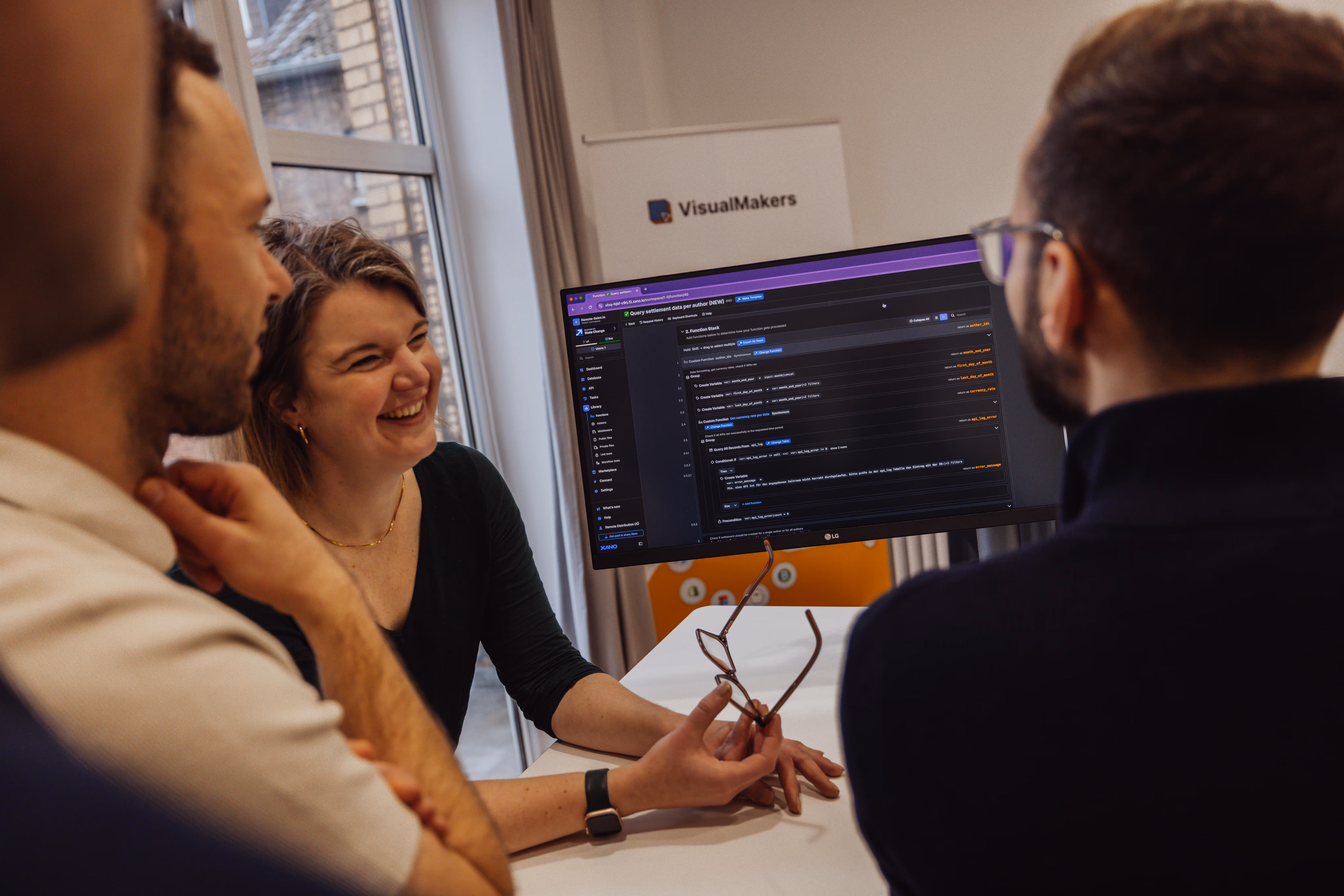 developers looking at desktop screen showing a no-code tool
