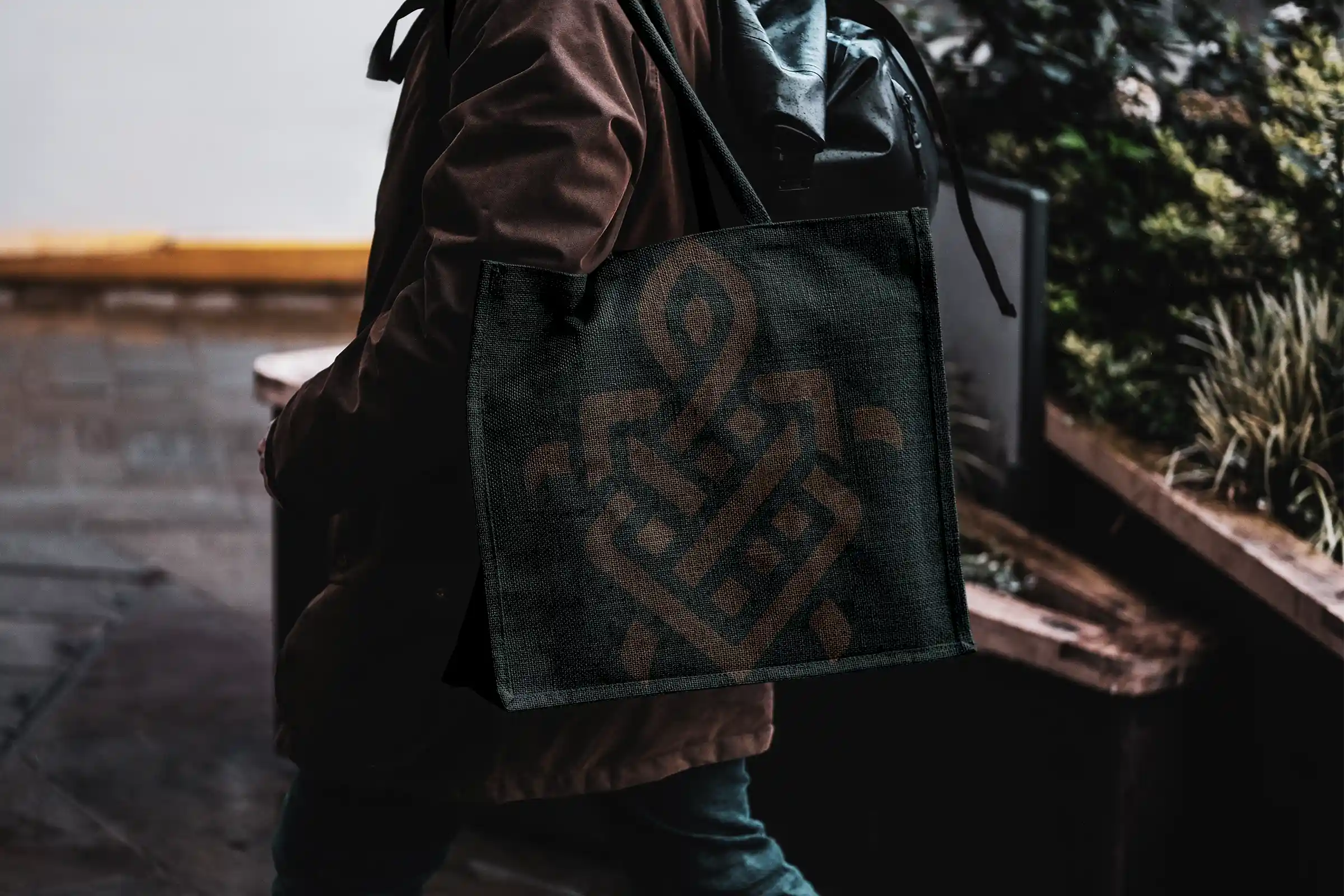 The iconic Testudo logo in our 'grounded' brown color printed on a sage green bag