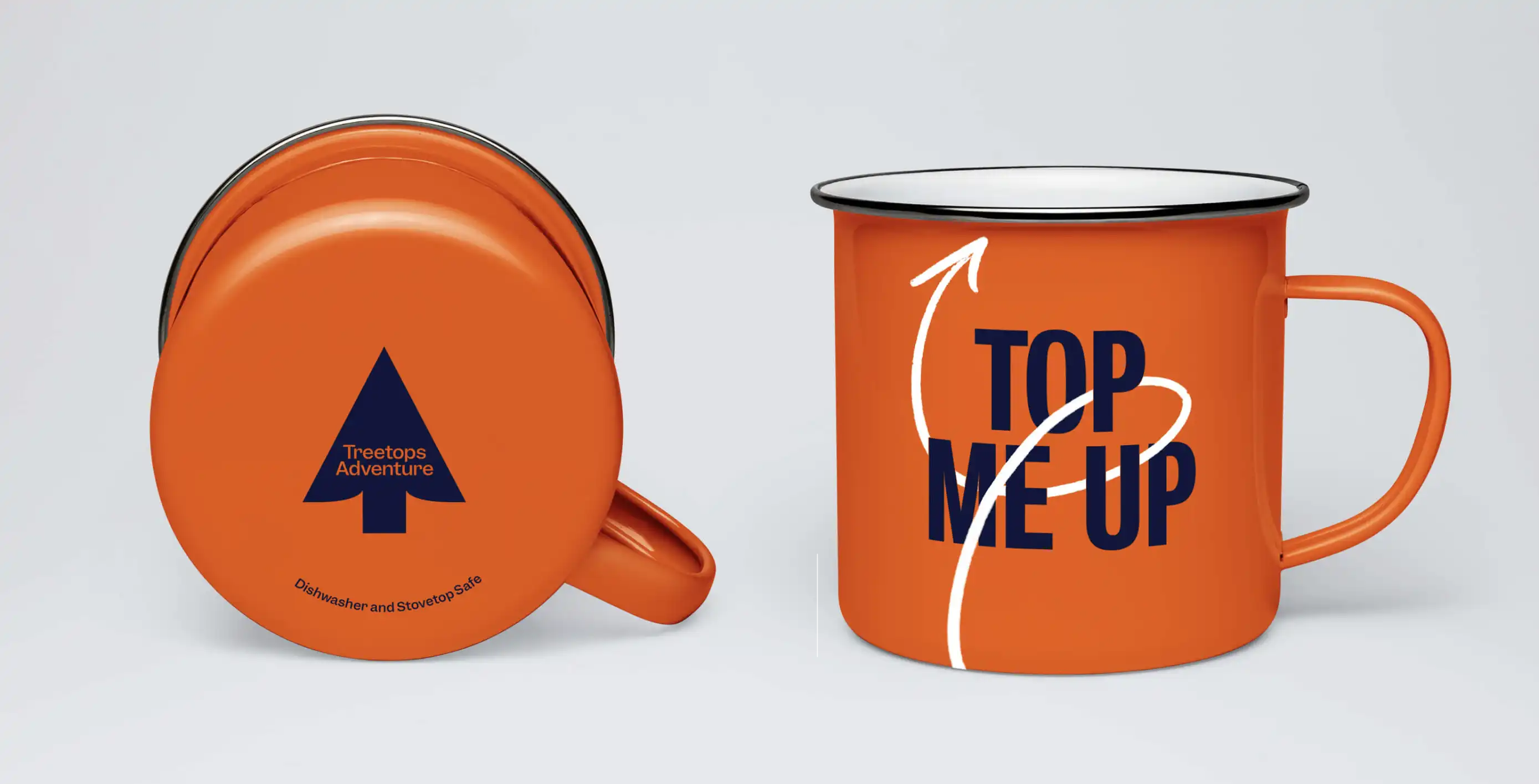 Some swag design for Treetop Adventures, showing off the branding on two enameled metal coffee mugs