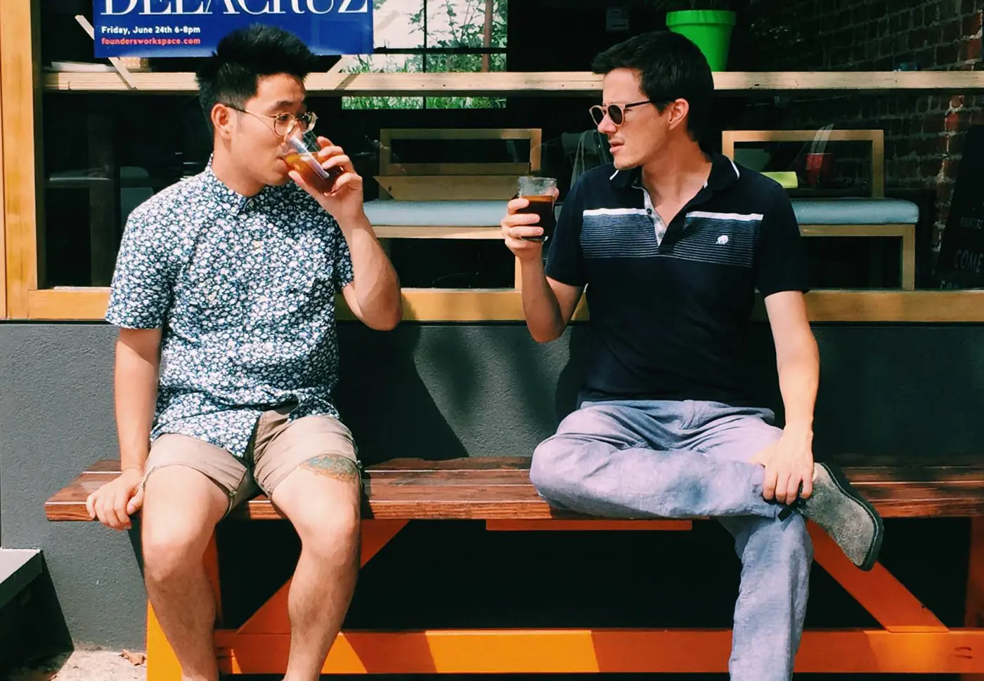 Thi Lam and Brent Lagerman sitting on a bench outside Founders Workspace drinking an early Keepers experimental batch.