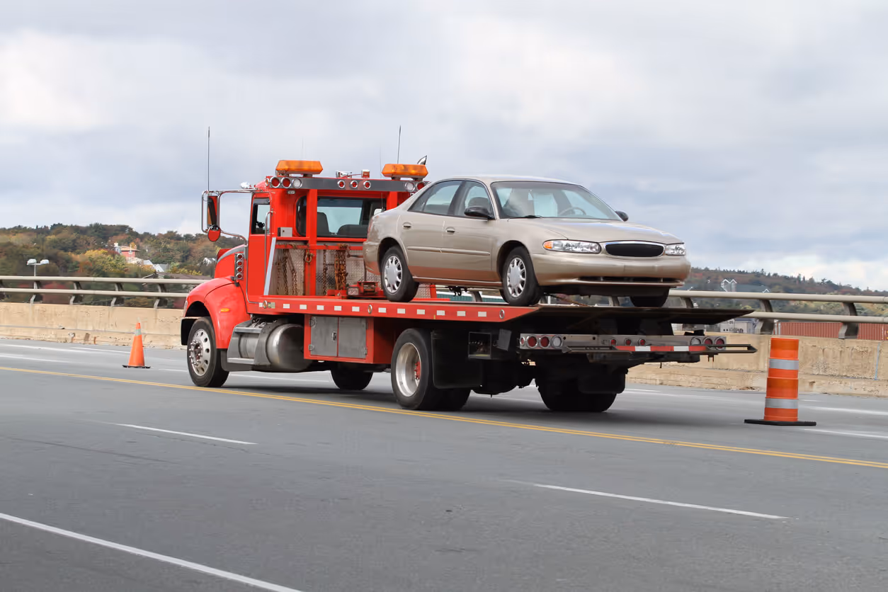 tow truck operator insurance concept -Tilt Bed Tow Truck with car on it
