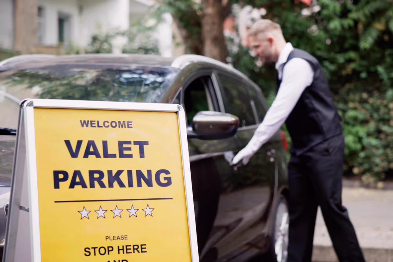 Man Giving Car Key To Male Valet