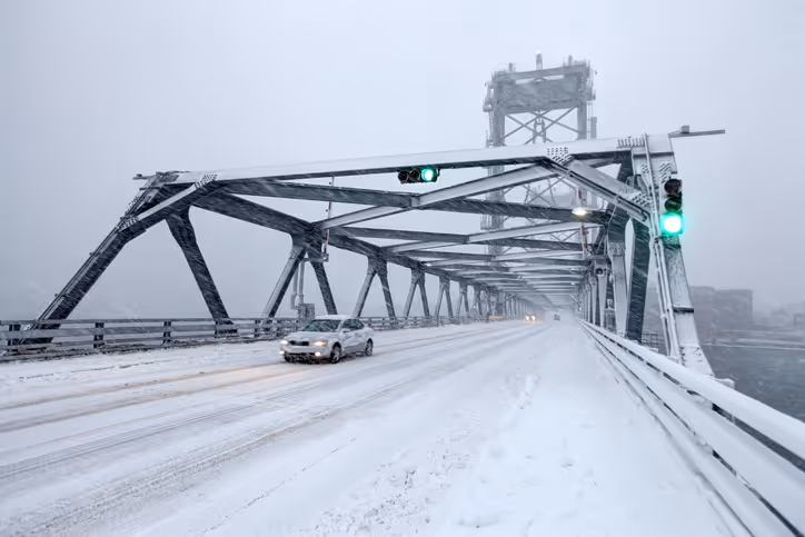 Blizzard in Portsmouth, New Hampshire with car on bridge - auto insurance N.H. concept