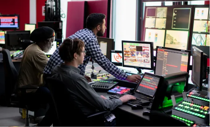 Workers working with many monitors as a team.