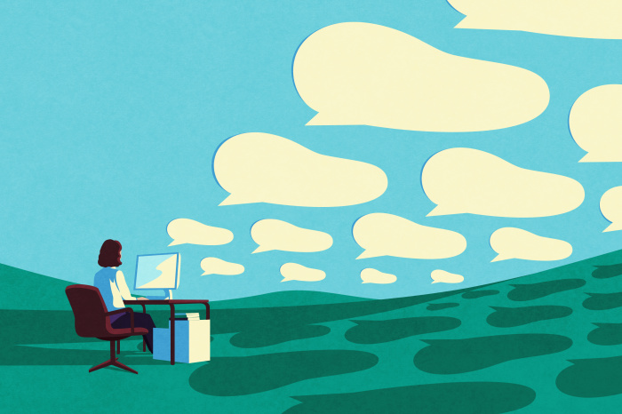 Illustration of a person sitting at a desk in front of a computer, with many speech bubbles above them.