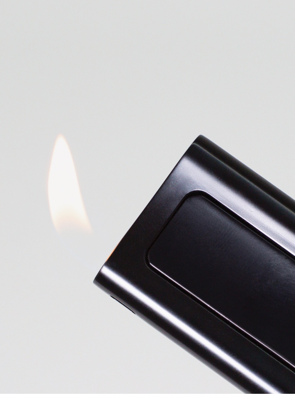 Lydian EP Black butane lighter with its flame lit