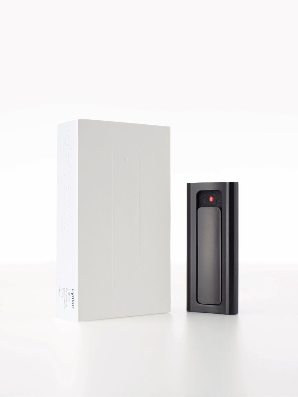 Lydian EP Black lighter beside its paper packaging