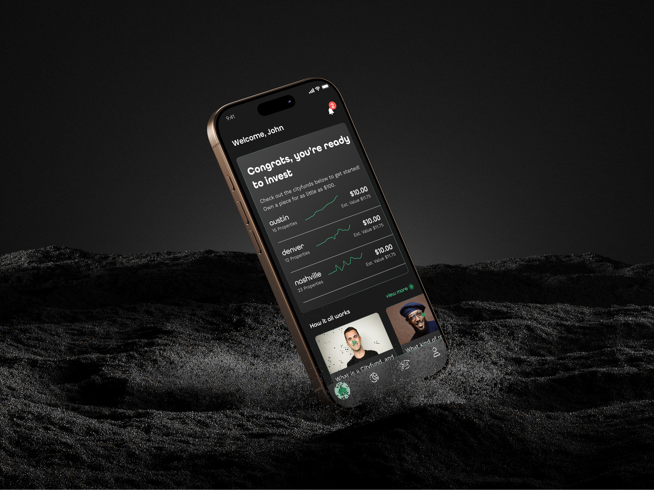 Phone in sand with home screen of Cityfunds by Nada