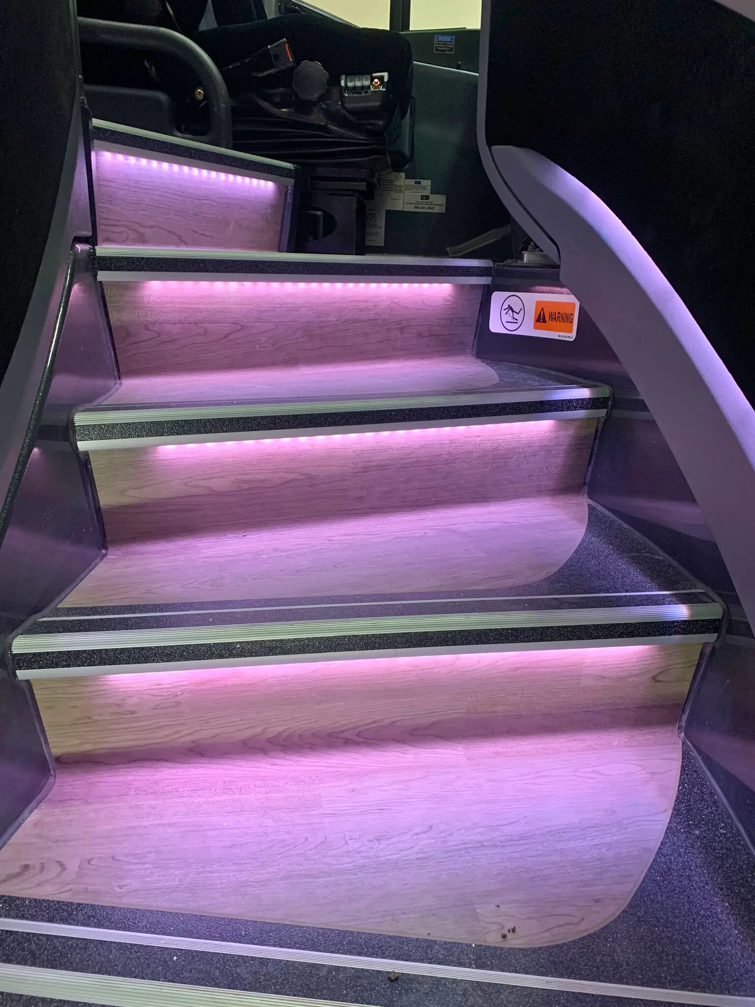 MCI J4500 motorcoach steps with LED interior spotlights, an enhanced technology feature