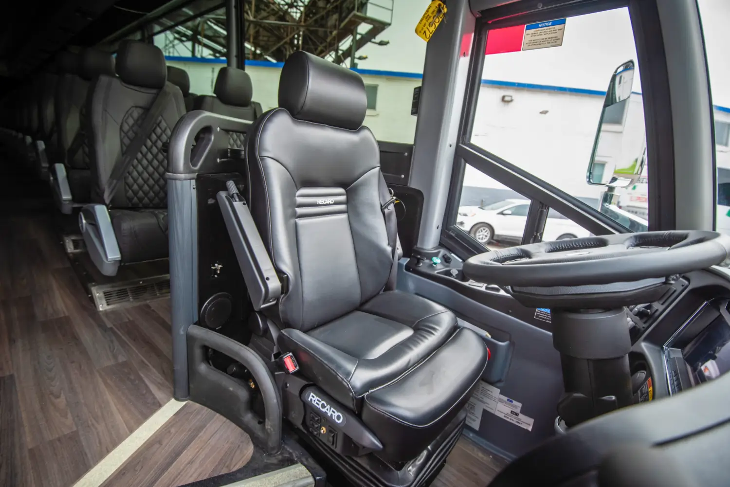 MCI J4500: Recaro driver's seat & controls for enhanced tech like LED lights, SmarTire.
