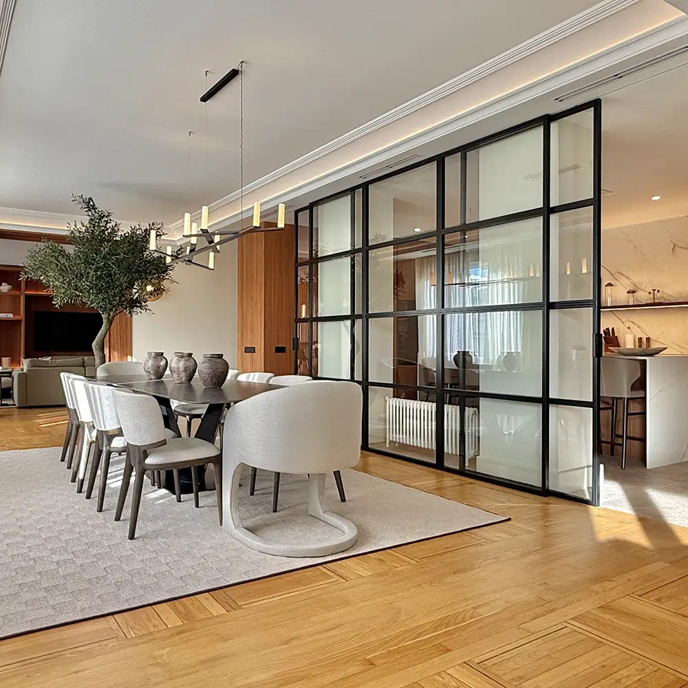 Simple black and white sketch of a house with a door, one window, and a bush on the right side.