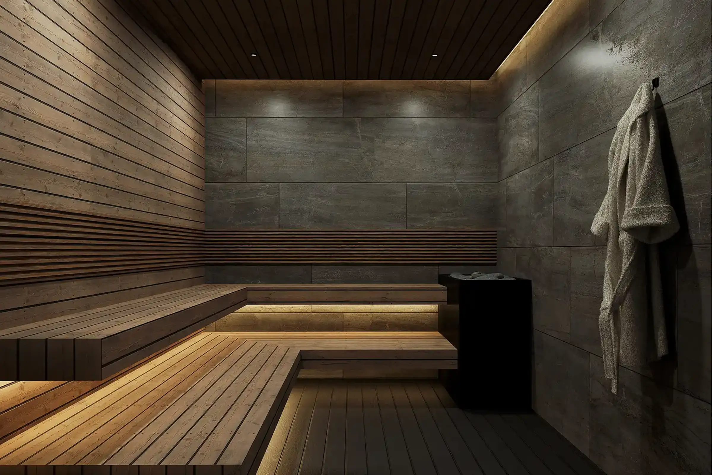Modern sauna interior with wooden benches, warm lighting, stone walls, and a hanging bathrobe.